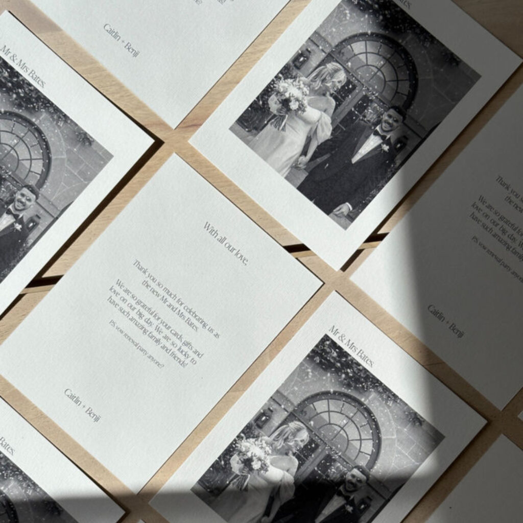 Black and white image of married couple on wedding day on one side of postcard and the other side has a thank you note from the couple
